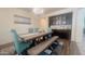 Elegant dining room features a farmhouse-style table, bench, and a sophisticated built-in cabinet at 24228 S 211Th St, Queen Creek, AZ 85142