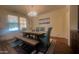 Bright dining room featuring a wooden table with chairs, a bench, and a modern chandelier at 24228 S 211Th St, Queen Creek, AZ 85142