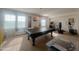 Spacious game room with natural light featuring a pool table and exercise equipment at 24228 S 211Th St, Queen Creek, AZ 85142