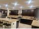 Spacious kitchen with dark wood cabinets, granite countertops, and stainless steel appliances at 24228 S 211Th St, Queen Creek, AZ 85142