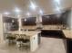 Spacious kitchen with dark wood cabinets, granite countertops, and stainless steel appliances at 24228 S 211Th St, Queen Creek, AZ 85142