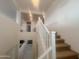 Staircase with white railings and carpeted stairs leads to the upper level of the home at 24228 S 211Th St, Queen Creek, AZ 85142