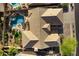 An aerial view shows a tiled roof, pool, turf, patio, and desert landscaping, capturing the essence of outdoor living at 2449 E Desert Flower Ln, Phoenix, AZ 85048