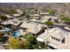 Desert home aerial view showcasing the pool, patio, lush landscaping, and beautiful surroundings at 2449 E Desert Flower Ln, Phoenix, AZ 85048
