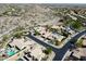 Aerial view of homes in a desert community featuring pools, desert landscaping, and tile roofs at 2449 E Desert Flower Ln, Phoenix, AZ 85048