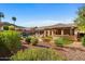 A backyard oasis with a swimming pool, lush landscaping, and an outdoor kitchen create an ideal space for relaxation and entertainment at 2449 E Desert Flower Ln, Phoenix, AZ 85048