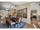Elegant dining room with a large wooden table, seating for eight, and stylish chandelier lighting at 2449 E Desert Flower Ln, Phoenix, AZ 85048