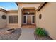 Close-up of the entrance showcasing a wooden front door with decorative accents and a cozy porch at 2449 E Desert Flower Ln, Phoenix, AZ 85048