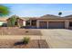 Charming single-story home featuring a well-maintained landscape, a two-car garage, and tile roofing at 2449 E Desert Flower Ln, Phoenix, AZ 85048