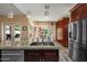 Modern kitchen with a central island, stainless steel appliances, and ample cabinet space with an eat in kitchen at 2449 E Desert Flower Ln, Phoenix, AZ 85048
