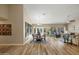 An open-concept living area featuring hardwood floors, a dining table and views of the backyard at 2449 E Desert Flower Ln, Phoenix, AZ 85048