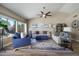 Inviting living space with vaulted ceilings, comfortable seating, a ceiling fan, and plenty of natural light at 2449 E Desert Flower Ln, Phoenix, AZ 85048