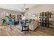 Bright living room with neutral tones, modern furnishings, a ceiling fan, and outdoor views at 2449 E Desert Flower Ln, Phoenix, AZ 85048
