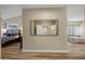 Spacious main bedroom featuring wood floors and leading to the main bathroom with glass enclosed shower at 2449 E Desert Flower Ln, Phoenix, AZ 85048