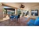 Covered outdoor patio with BBQ, dining furniture, and a seating area overlooking the backyard at 2449 E Desert Flower Ln, Phoenix, AZ 85048