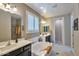 Bright primary bathroom with double sink vanity, soaking tub and shuttered window at 2468 W Dapple Gray Ct, San Tan Valley, AZ 85144