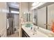 Bathroom with vanity featuring a sink, mirror, and a shower/tub combination with a shower curtain at 2468 W Dapple Gray Ct, San Tan Valley, AZ 85144