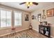 Bedroom with wood flooring, ceiling fan, and bright window at 2468 W Dapple Gray Ct, San Tan Valley, AZ 85144