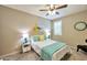 Bright bedroom with soft carpet, turquoise accents and a ceiling fan at 2468 W Dapple Gray Ct, San Tan Valley, AZ 85144