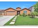 Charming single-story home with a well-manicured lawn, beautiful landscaping, and a two-car garage at 2468 W Dapple Gray Ct, San Tan Valley, AZ 85144