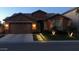 Exterior shot of a single-story home at night with a desert landscape and an attached two-car garage at 2468 W Dapple Gray Ct, San Tan Valley, AZ 85144