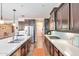 Spacious kitchen with dark cabinets, a large island, stainless steel appliances, and open layout at 2468 W Dapple Gray Ct, San Tan Valley, AZ 85144