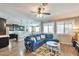 Inviting living room with an open floor plan, a plush blue sectional, and plenty of natural light at 2468 W Dapple Gray Ct, San Tan Valley, AZ 85144