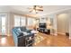 Cozy living room featuring a comfortable blue sectional, modern decor, and plenty of natural light at 2468 W Dapple Gray Ct, San Tan Valley, AZ 85144