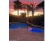 Backyard pool and jacuzzi with palm trees during sunset at 2468 W Dapple Gray Ct, San Tan Valley, AZ 85144
