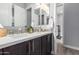 This bathroom features a double vanity with white countertop, backsplash, and mirrors at 26699 N 104Th Way, Scottsdale, AZ 85262