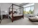 Bright bedroom with a four-poster bed, a large window, and neutral-toned decor at 26699 N 104Th Way, Scottsdale, AZ 85262