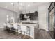 Spacious kitchen featuring a large island with seating, stylish pendant lights, and stainless steel appliances at 26699 N 104Th Way, Scottsdale, AZ 85262