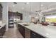Gourmet kitchen with stainless steel appliances, island seating, and sliding glass door at 26699 N 104Th Way, Scottsdale, AZ 85262