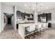Open kitchen with dark cabinets, large island, pendant lighting, breakfast bar and stainless steel appliances at 26699 N 104Th Way, Scottsdale, AZ 85262