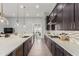 Kitchen featuring quartz countertops, dark cabinetry, and stainless steel appliances at 26699 N 104Th Way, Scottsdale, AZ 85262