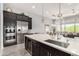 Modern kitchen showcasing a large island with seating, stainless steel appliances, and an open layout at 26699 N 104Th Way, Scottsdale, AZ 85262
