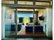 View of outdoor living room with hot tub and television through glass sliding doors at 26699 N 104Th Way, Scottsdale, AZ 85262
