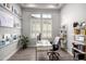 Bright home office with modern desk, shelving, and wood-look tile floors at 26699 N 104Th Way, Scottsdale, AZ 85262