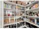 Walk-in pantry featuring organized shelving, clear storage containers, and a variety of food items at 26699 N 104Th Way, Scottsdale, AZ 85262