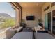 Inviting covered patio with comfortable seating, fire pit, and stunning mountain views at 26699 N 104Th Way, Scottsdale, AZ 85262