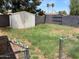 View of the backyard with a detached storage shed and chain link fence at 2834 E Juanita Ave, Mesa, AZ 85204