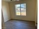 Bedroom features faux wood flooring, light colored walls, and a window at 2834 E Juanita Ave, Mesa, AZ 85204