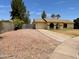 Single-story home with desert landscaping, a two-car garage, and drought-tolerant plants at 2834 E Juanita Ave, Mesa, AZ 85204