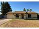 Inviting single-story home with a two-car garage, an arched entryway, and a neatly kept front yard at 2834 E Juanita Ave, Mesa, AZ 85204
