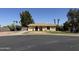 Single story home with a two car garage, desert landscaping and mature shade trees at 2834 E Juanita Ave, Mesa, AZ 85204