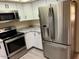 Kitchen features stainless steel appliances, white cabinets and light gray countertops at 2834 E Juanita Ave, Mesa, AZ 85204
