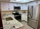 Updated kitchen featuring stainless steel appliances, white cabinets and granite countertops at 2834 E Juanita Ave, Mesa, AZ 85204
