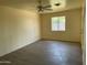 Neutral living area with a large window, ceiling fan and updated flooring at 2834 E Juanita Ave, Mesa, AZ 85204