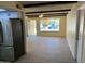 Open floor plan living room with white cabinets and stainless refrigerator at 2834 E Juanita Ave, Mesa, AZ 85204