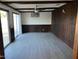 Spacious living area with updated flooring, wood paneling, ceiling fan and sliding glass doors at 2834 E Juanita Ave, Mesa, AZ 85204